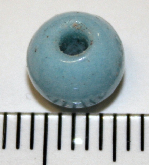 Lucite(?) bead, on floor of trench 1B